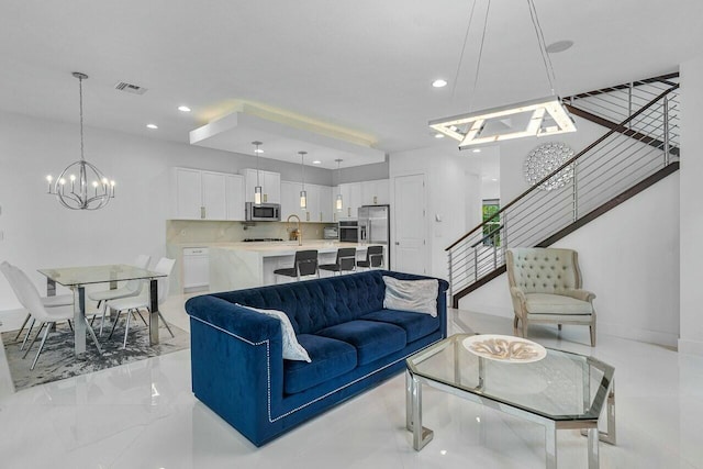 living room with sink and a chandelier