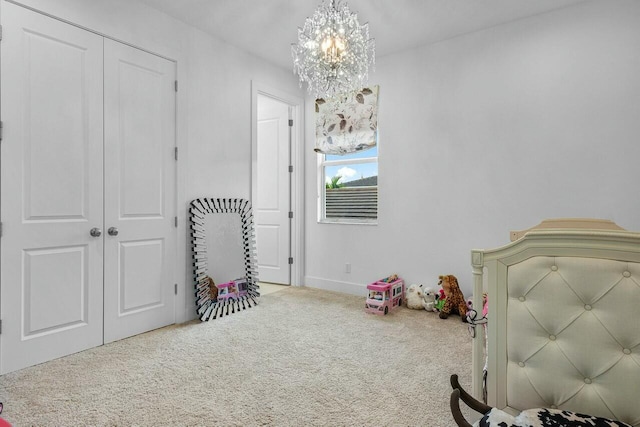 carpeted bedroom with an inviting chandelier and a closet