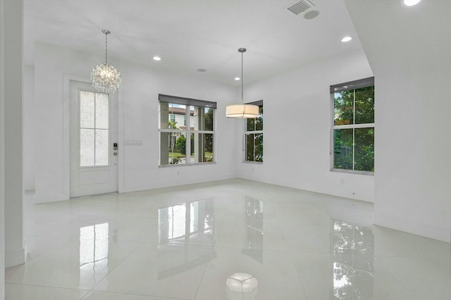 unfurnished dining area featuring a notable chandelier