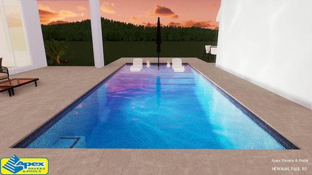 pool at dusk featuring a patio