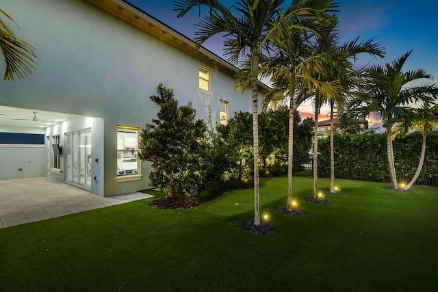 yard at dusk with a patio