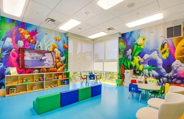 playroom with a paneled ceiling