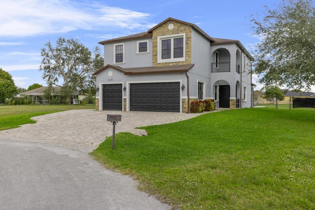 view of front of home featuring a garage, a front lawn, and a balcony