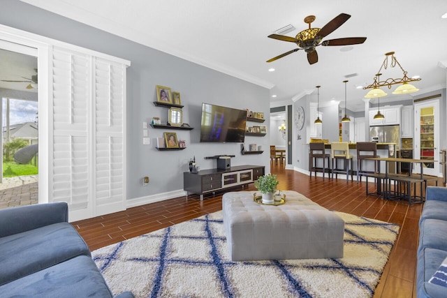 living room with crown molding and ceiling fan