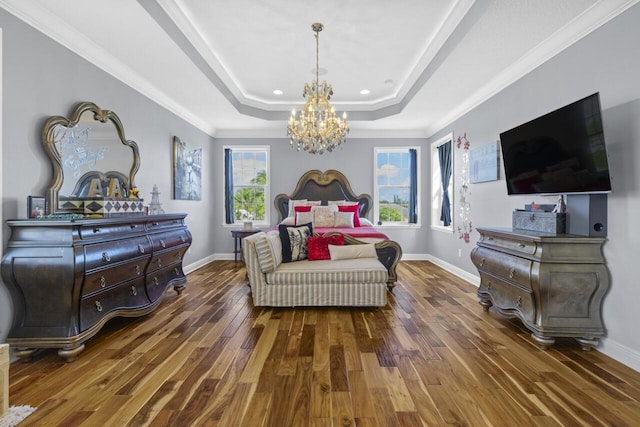 bedroom with dark wood-type flooring, ornamental molding, a raised ceiling, and a notable chandelier