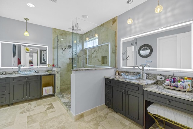 bathroom featuring tiled shower and vanity