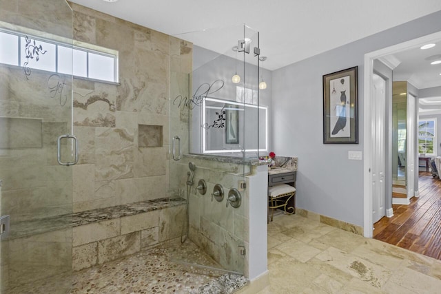 bathroom with crown molding, a wealth of natural light, and a shower with shower door