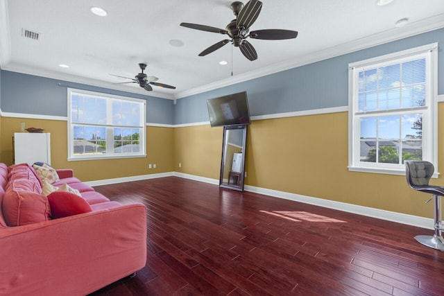 living room with ornamental molding, a healthy amount of sunlight, and hardwood / wood-style floors