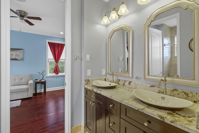 bathroom with vanity, crown molding, hardwood / wood-style floors, and ceiling fan