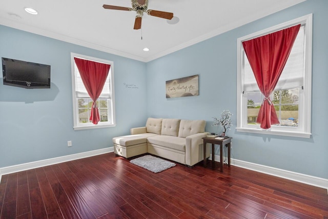 living room featuring crown molding, ceiling fan, a healthy amount of sunlight, and hardwood / wood-style floors