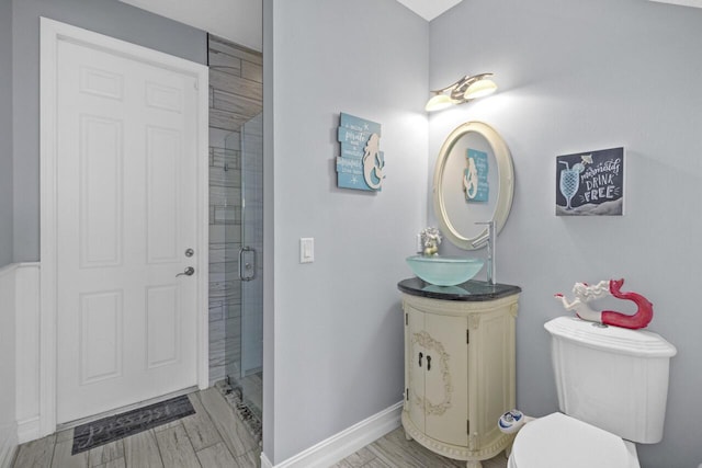 bathroom featuring vanity, hardwood / wood-style floors, toilet, and walk in shower