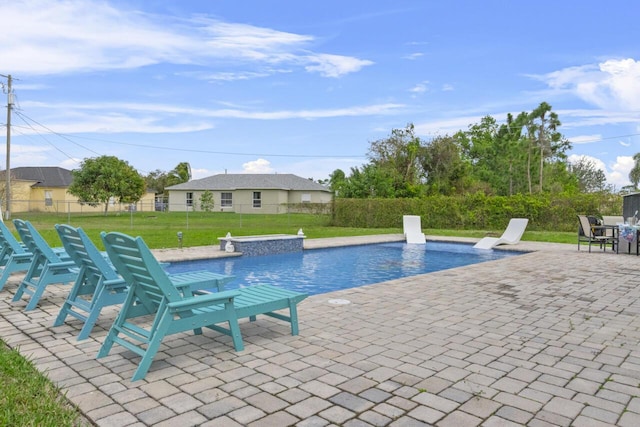 view of swimming pool featuring a patio and a yard