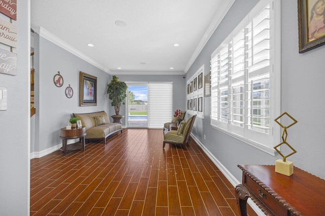 living area with crown molding and dark hardwood / wood-style floors