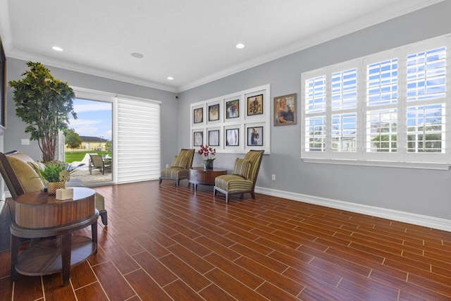 sitting room featuring ornamental molding and dark wood-type flooring