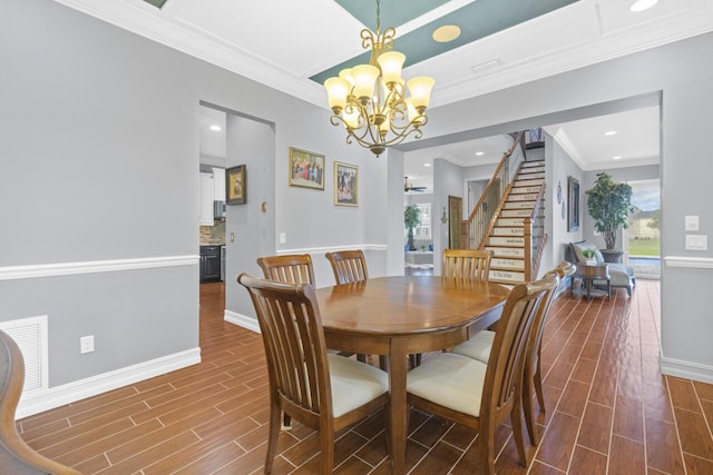 dining space with crown molding and a notable chandelier