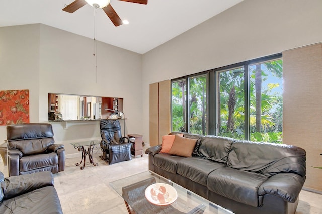 living room with ceiling fan, a wealth of natural light, and high vaulted ceiling