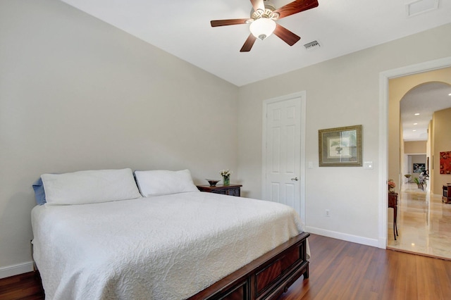 bedroom with dark wood-type flooring and ceiling fan