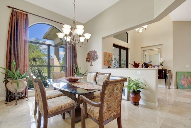 dining room featuring an inviting chandelier and a high ceiling