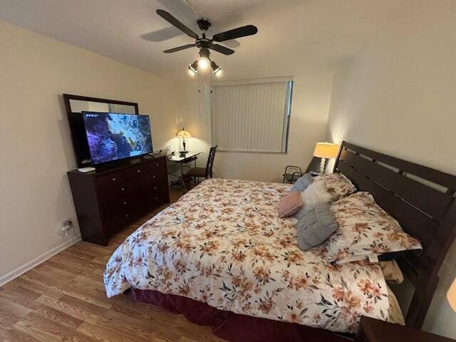 bedroom with ceiling fan and hardwood / wood-style floors