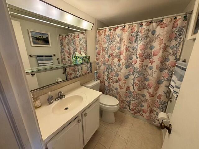 bathroom with vanity, tile patterned flooring, a shower with curtain, and toilet