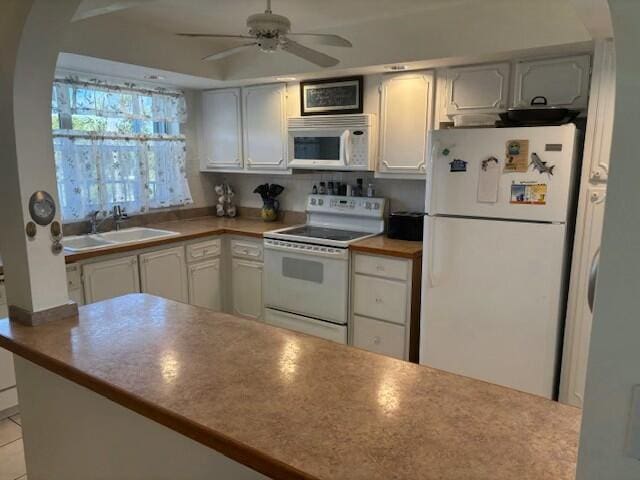 kitchen with light tile patterned floors, sink, white appliances, ceiling fan, and white cabinets