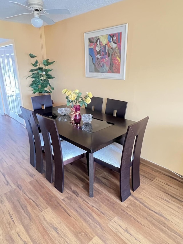 dining room featuring ceiling fan and light hardwood / wood-style floors