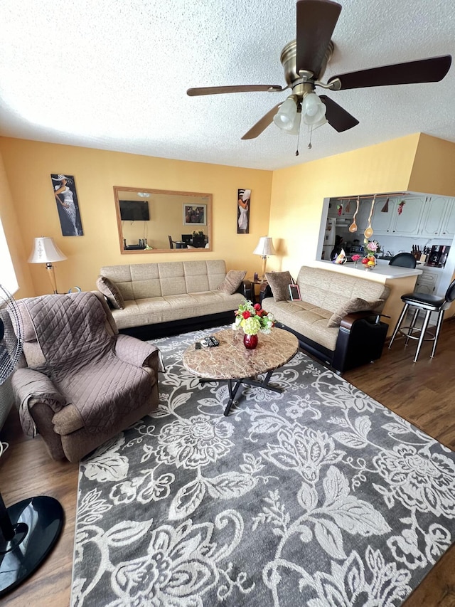 living room with hardwood / wood-style floors and a textured ceiling