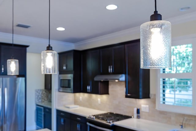 kitchen with crown molding, tasteful backsplash, stainless steel appliances, and pendant lighting