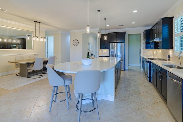 kitchen featuring hanging light fixtures, crown molding, appliances with stainless steel finishes, and sink