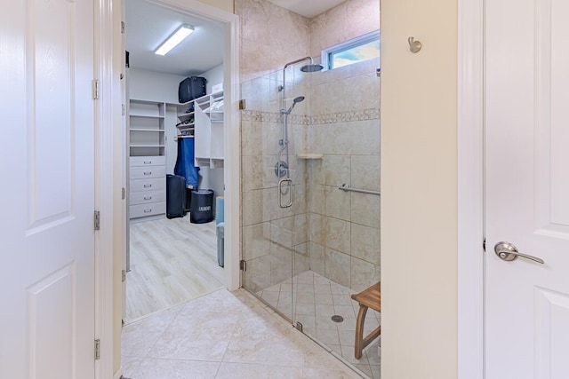 bathroom featuring a shower with door