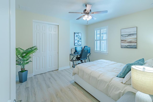 bedroom featuring ceiling fan, light wood-type flooring, and a closet