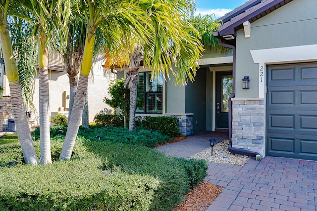 view of exterior entry featuring a garage