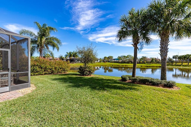 view of yard featuring a water view and a lanai