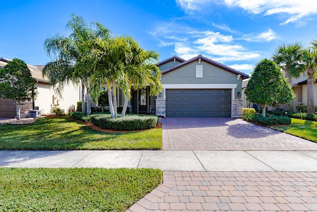 view of front of home featuring a front lawn and a garage