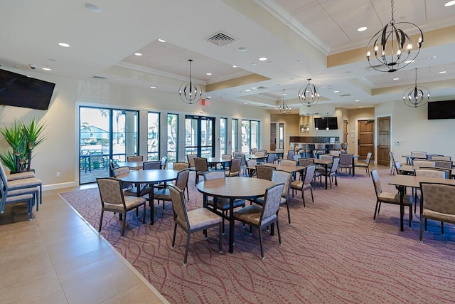 dining room with crown molding, a chandelier, a tray ceiling, and tile patterned flooring