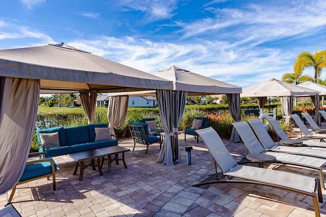 view of patio featuring an outdoor living space and a gazebo