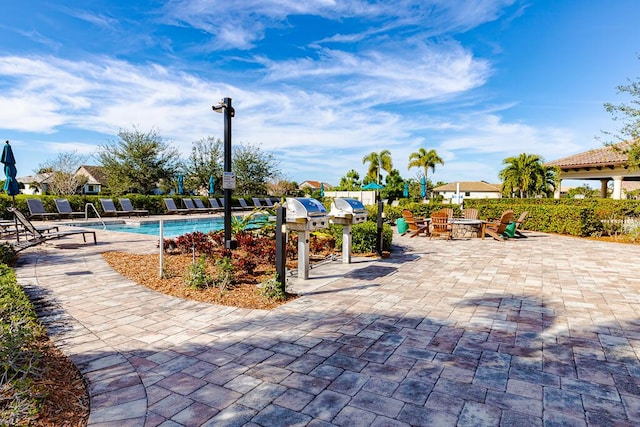 exterior space featuring a fire pit and a community pool