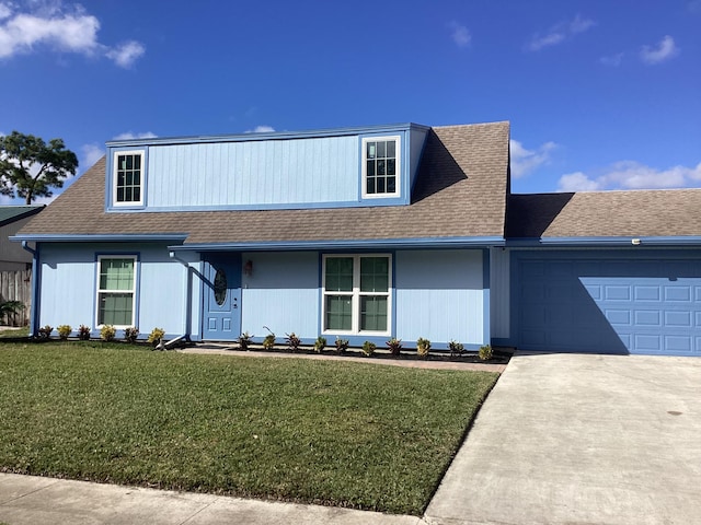 view of front of house with a garage and a front yard