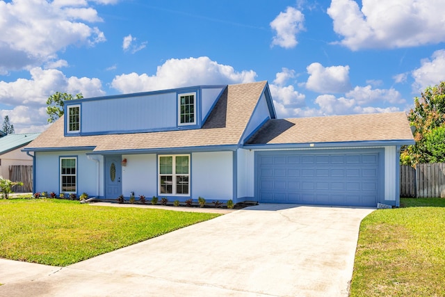 view of front of property featuring a front lawn, concrete driveway, an attached garage, and fence