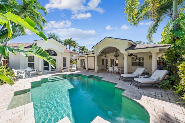 view of pool with a patio, ceiling fan, and french doors