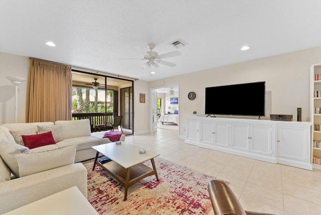 tiled living room featuring a textured ceiling and ceiling fan