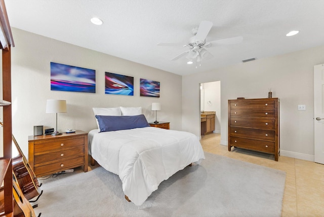 bedroom featuring connected bathroom, ceiling fan, and light tile patterned flooring