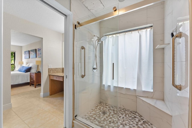 bathroom with an enclosed shower and tile patterned flooring