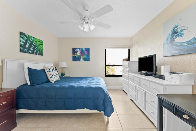 bedroom featuring ceiling fan, a textured ceiling, and light tile patterned floors