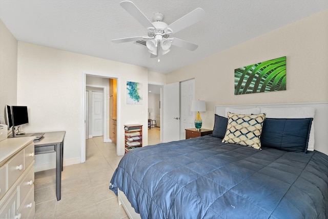 tiled bedroom featuring a textured ceiling and ceiling fan