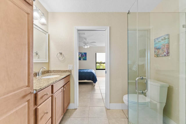 bathroom featuring tile patterned floors, toilet, an enclosed shower, vanity, and ceiling fan