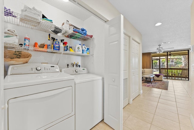 laundry room with separate washer and dryer, light tile patterned floors, a textured ceiling, and ceiling fan