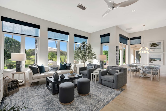 living room featuring ceiling fan and light wood-type flooring