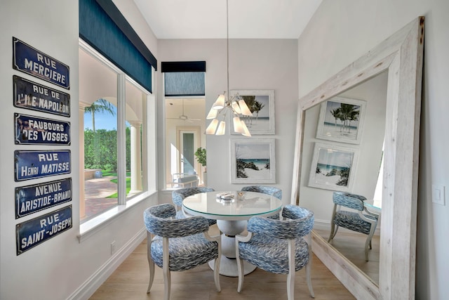 dining space with light hardwood / wood-style floors and ceiling fan