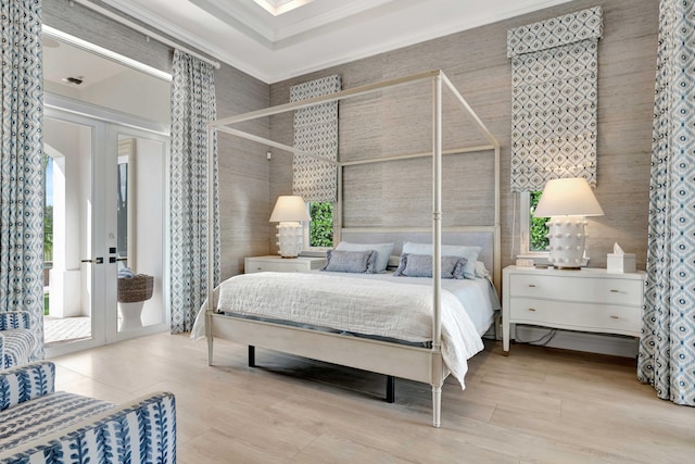 bedroom featuring multiple windows, crown molding, access to outside, and french doors